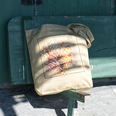Outdoor photo of our red lionfish tote bag.