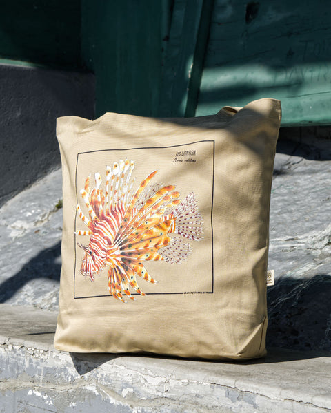 Outdoor photo of our red lionfish tote bag.