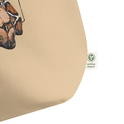 Product mockup of our organic tote bag with a boa constrictor print, shown here is a detail of the organic logo.
