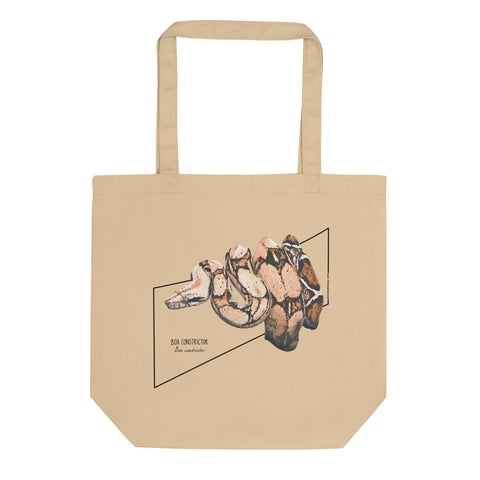 Product mockup of our organic tote bag featuring a boa constrictor, here seen lying flat on a surface.