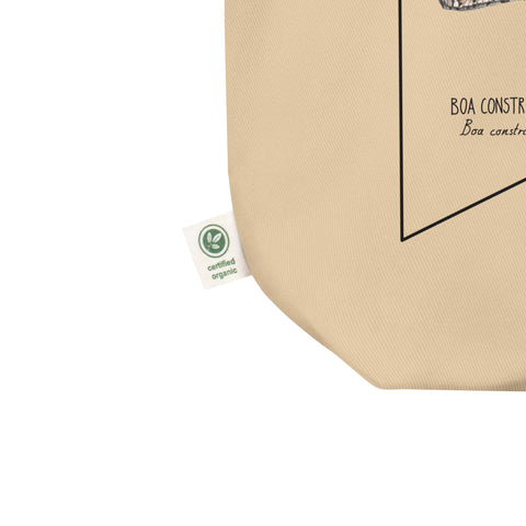 Product mockup of our organic tote bag featuring a boa constrictor, here showing the organic label detail.