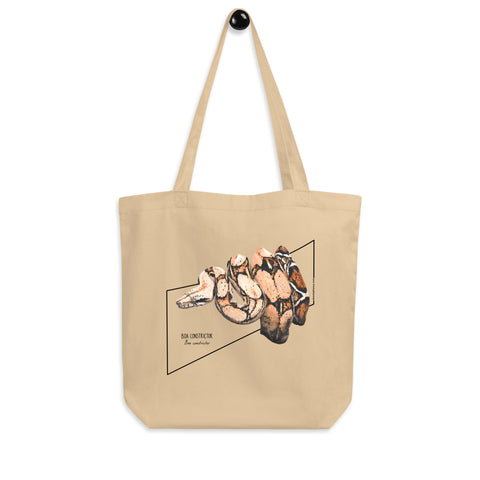 Product mockup of our organic tote bag featuring a boa constrictor, here seen hanging from the handles.
