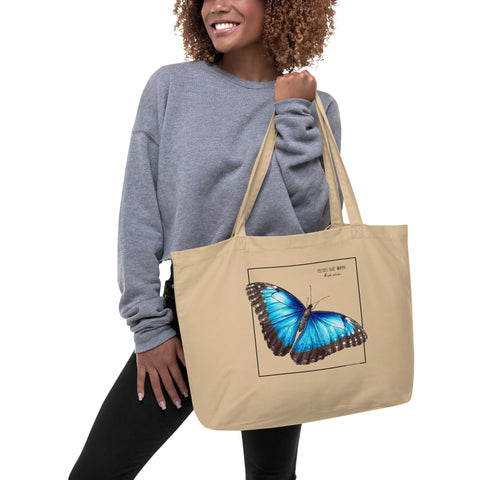 A model carrying a mock up of our blue morpho tote bag. Versatile, sturdy, this bag can be used as shopping bag, gym bag or as any everyday bag. Or present!