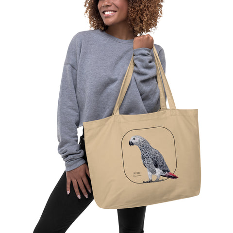 A model holding a mock up of our tote bag. This sturdy bag comes with a beautiful print of a hand-drawn juvenile grey parrot. 100% organic cotton. Beach bag, shopping bag, travel bag, or just as a present. PETA-approved vegan.