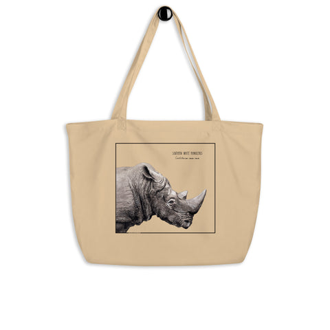 Product mockup of our tote bag with beautiful, carefully drawn southern white rhinoceros printed on the front side of the bag. Here hanging from a hanger.