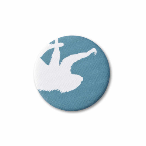 A teal-blue, fabric-covered magnet with the silhouette of a two-fingered sloth on a flat white surface.