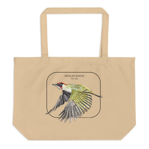 Product mockup of our 100% organic tote bag with a european green woodpecker print. Here lying flat on a white surface.
