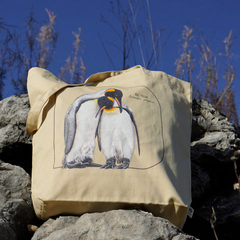 This sturdy tote bag comes with a beautiful print of a hand-drawn pair of king penguins huddled together. 100% organic cotton. Beach bag, shopping bag, travel bag, or just as a present.