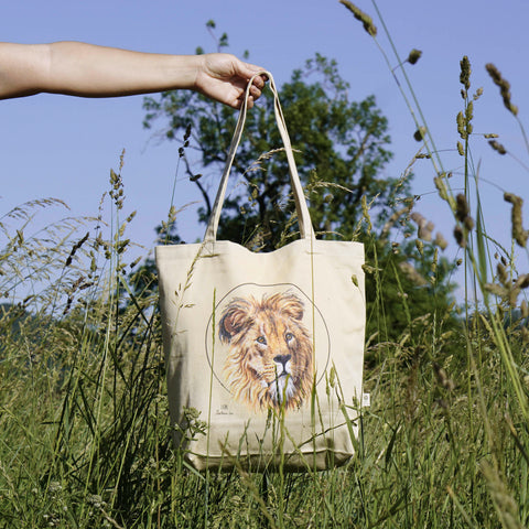 Outside photo of our organic tote bag, featuring a lion. It's perfect as gym bag, grocery bag or any place you might need a sturdy, reusable bag!