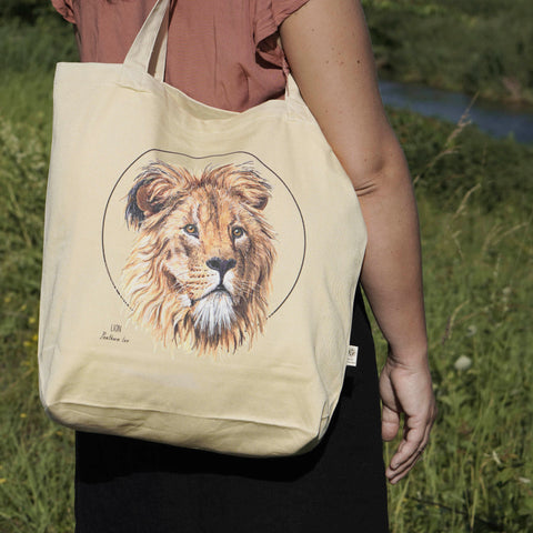 Outside photo of our organic tote bag, featuring a lion. It's perfect as gym bag, grocery bag or any place you might need a sturdy, reusable bag!