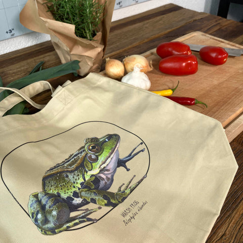 Standard size tote bag made from 100% organic cotton. This marsh frog print was lovingly hand-crafted with lots of detail. Here we use it for groceries.