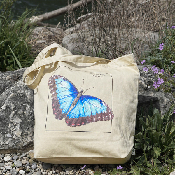 Photo of our blue morpho tote bag in sunlight. Versatile, sturdy, this bag can be used as shopping bag, gym bag or as any everyday bag!