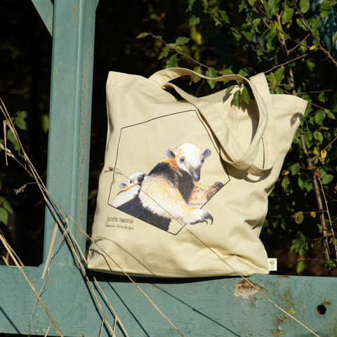 Our sturdy, spacious tote bag, this one features a friendly reticulated giraffe. 100% organic cotton. Beach bag, shopping bag, library bag or just a present! Here in sunlight.