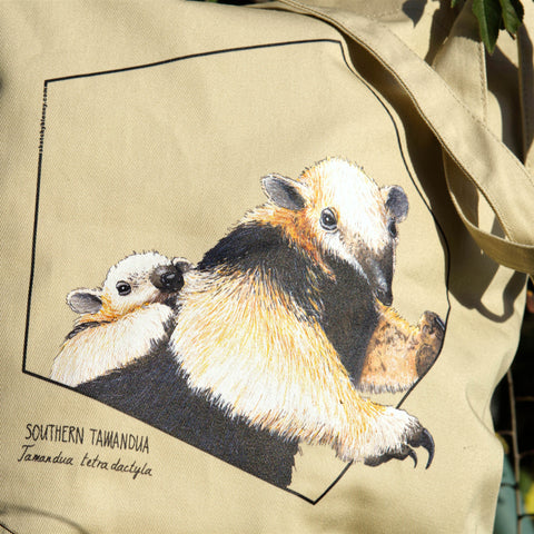 Our sturdy, spacious tote bag, this one features a friendly reticulated giraffe. 100% organic cotton. Beach bag, shopping bag, library bag or just a present! Here in sunlight.