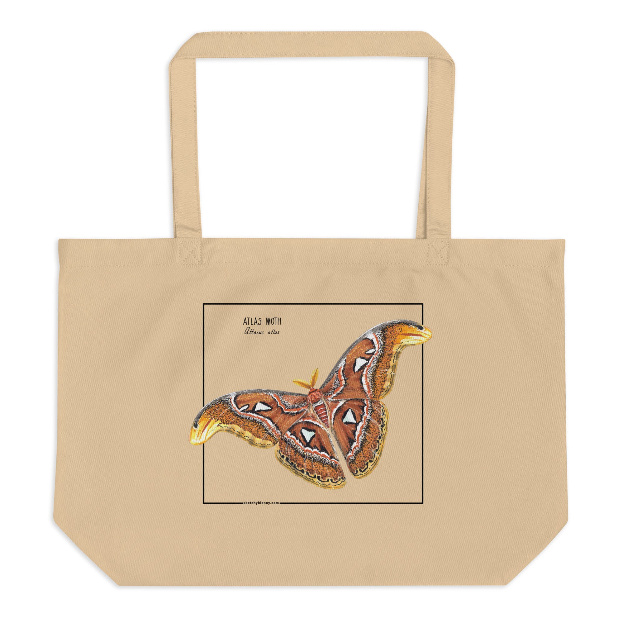 Product mockup of our large organic tote bag, featuring an atlas moth. Here seen lying on a flat surface.