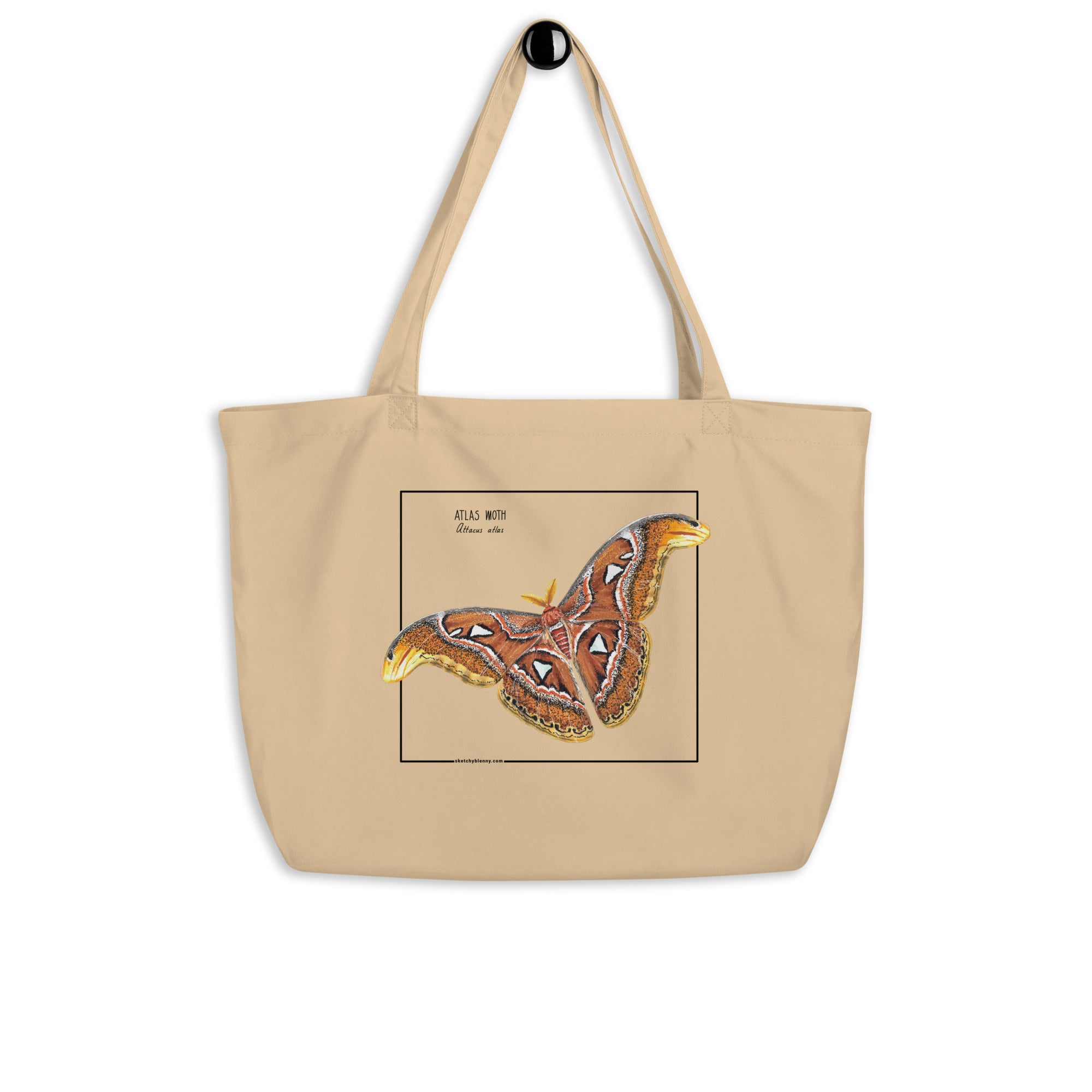 Product mockup of our large organic tote bag, featuring an atlas moth. Here seen hanging from the handles.