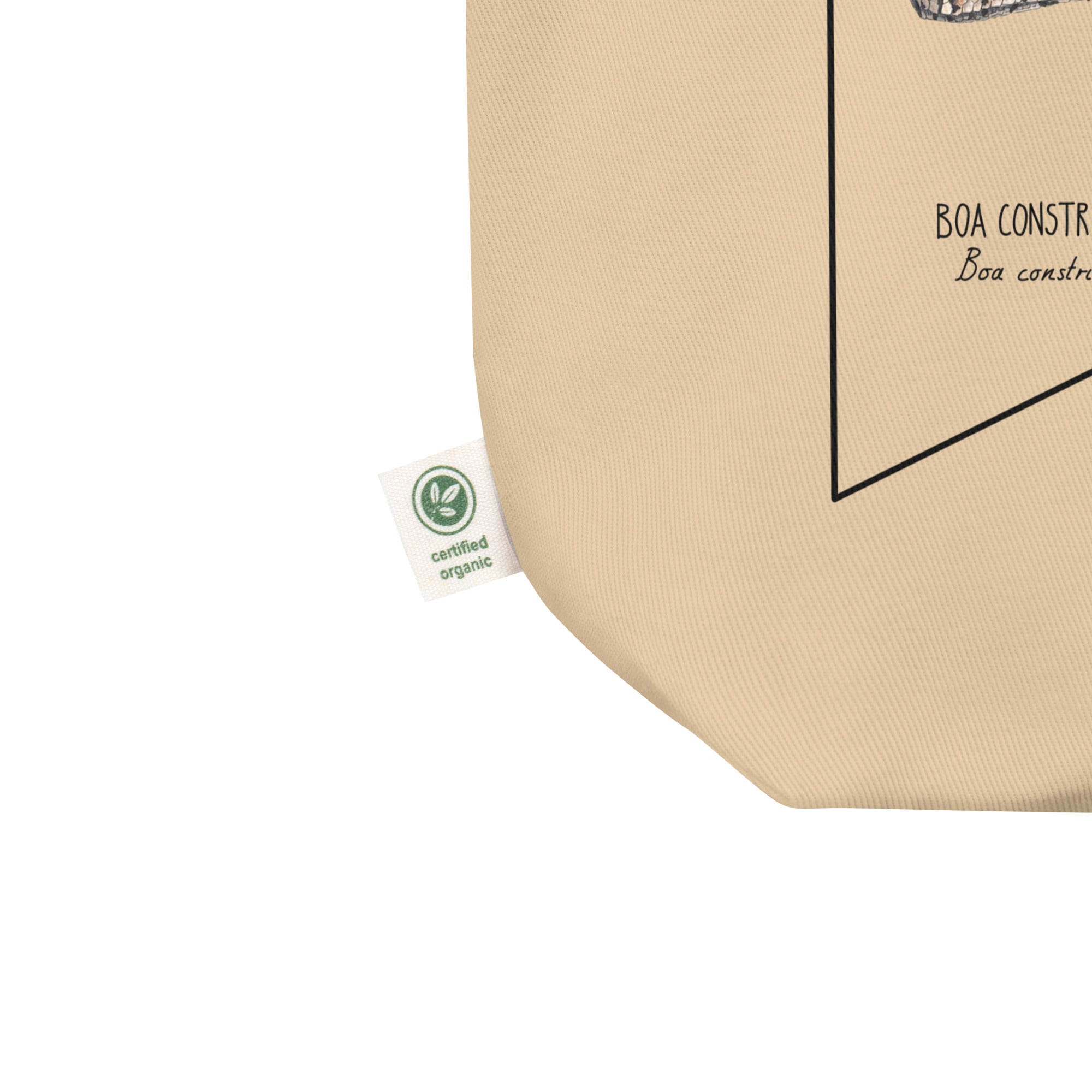 Product mockup of our organic tote bag featuring a boa constrictor, here showing the organic label detail.