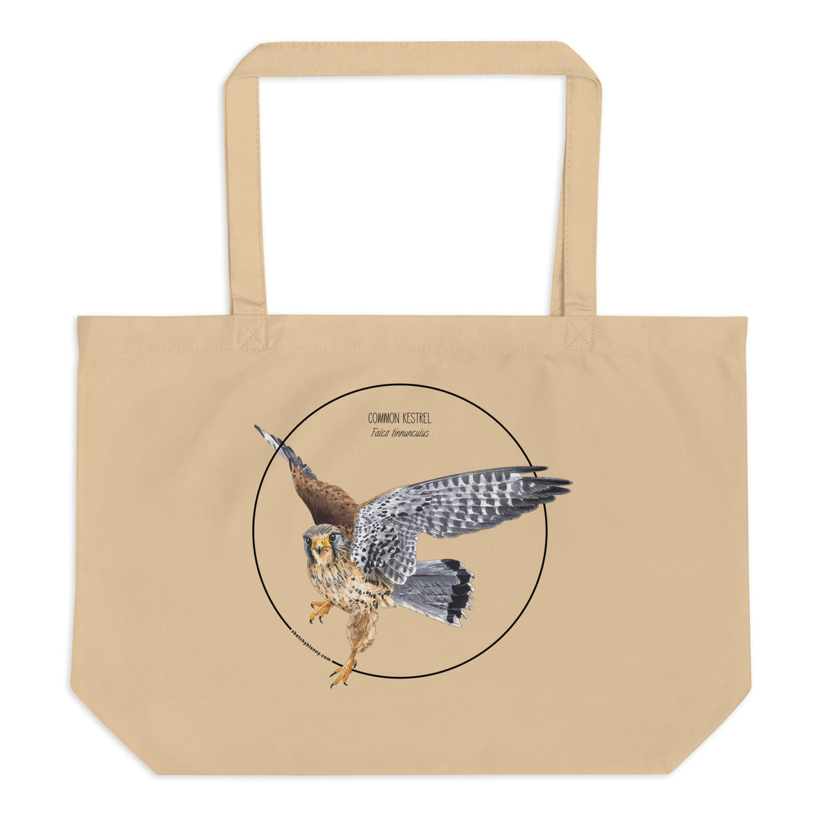 Product mockup of the large organic tote bag featuring a kestrel print. Here lying on a flat white surface.
