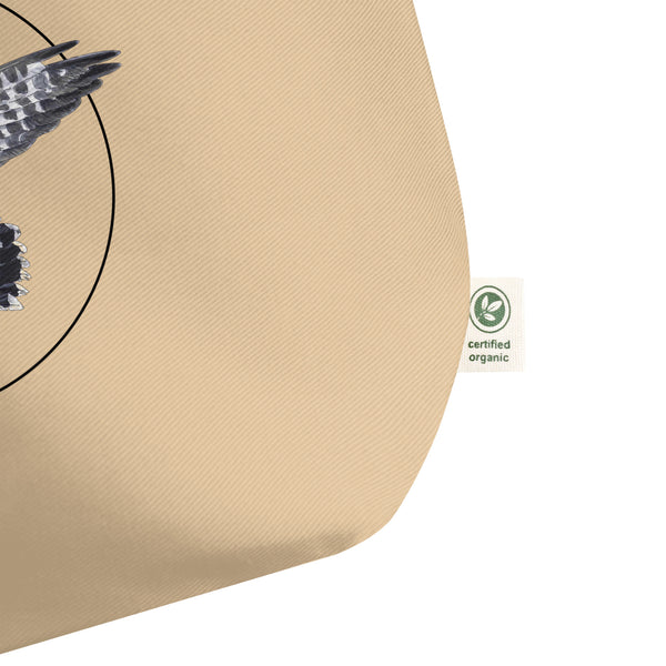 Product mockup of the large organic tote bag featuring a kestrel print. Here  showing the detail of the organic label.