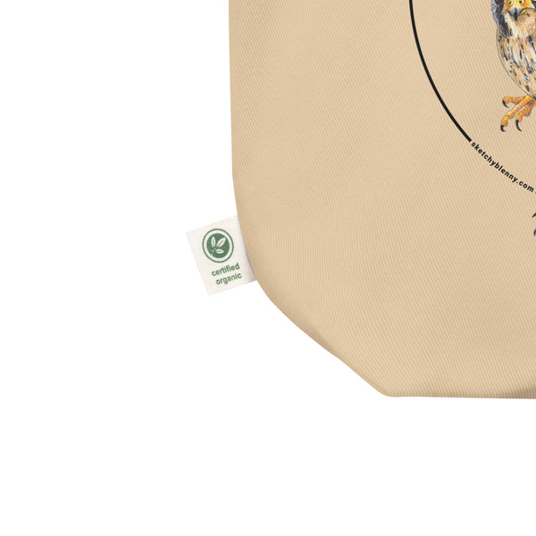 Product mockup of the organic tote bag featuring a kestrel print. Here showing the organic label detail.