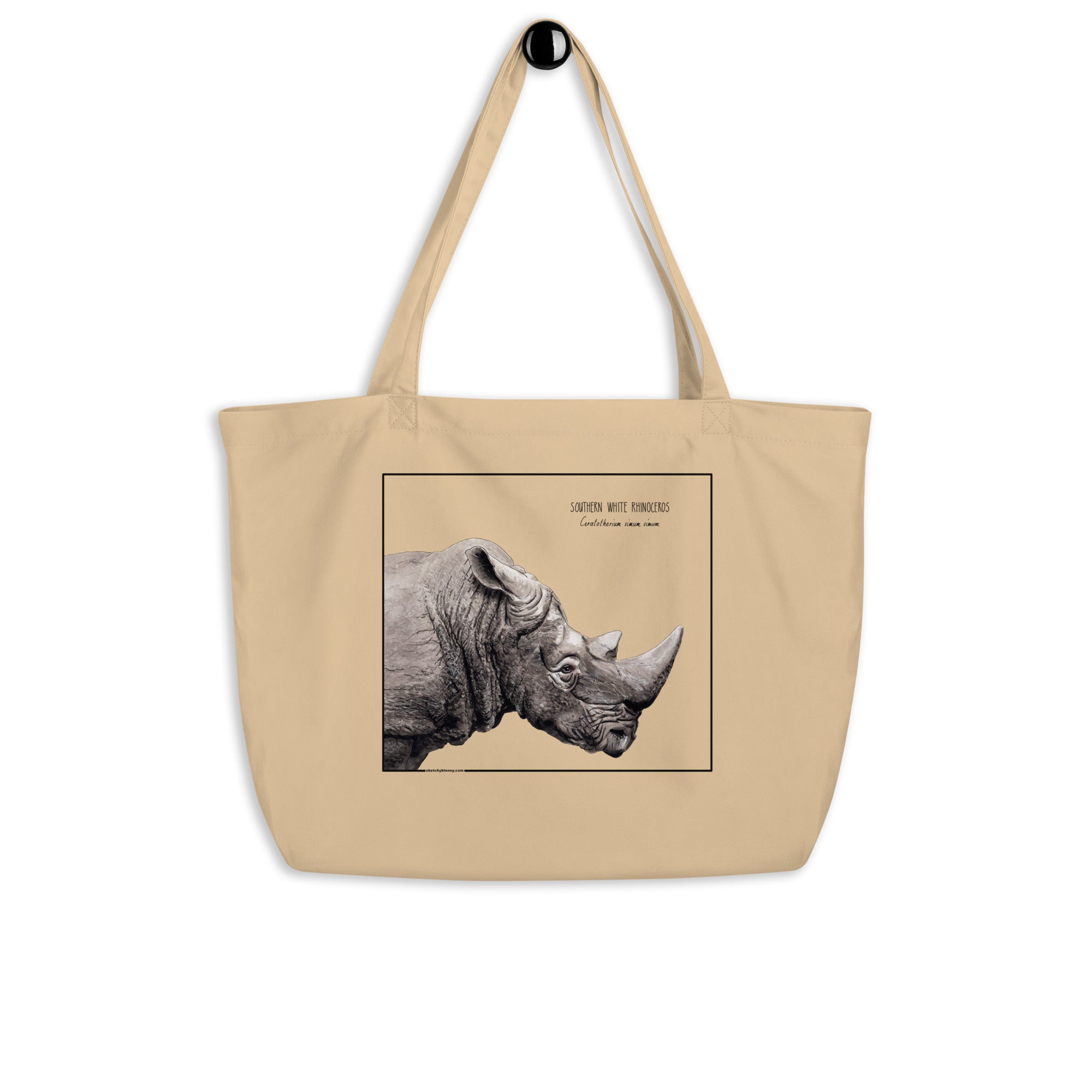 Product mockup of our tote bag with beautiful, carefully drawn southern white rhinoceros printed on the front side of the bag. Here hanging from a hanger.