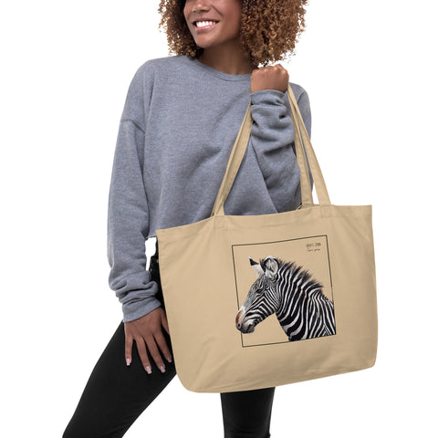 A model holding our tote bag with a beautiful, life-like print of a hand-drawn Grévy's Zebra. 100% organic cotton. Beach bag, shopping bag, travel bag, or just as a present.