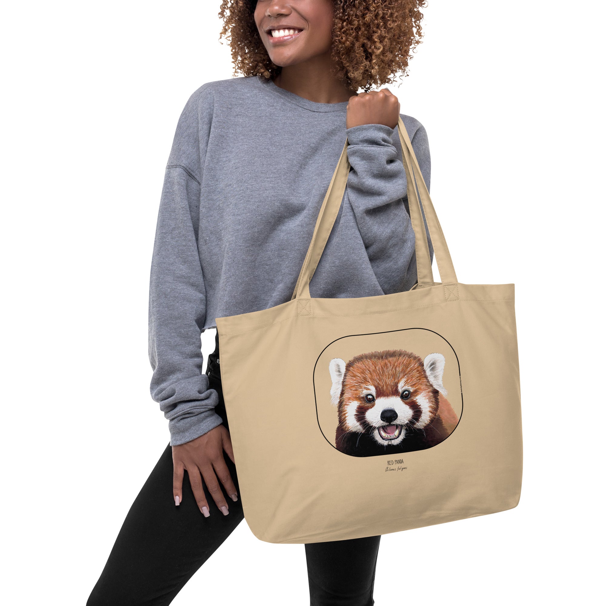 Product mockup of the large organic cotton tote bag with cheeky red panda print, here with a model
