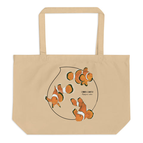 Product mockup of our large organic tote bag and a print of 3 hand-drawn common clownfishes. Here the bag lies flat on a surface.