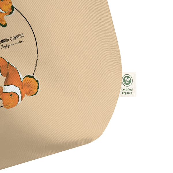 Product mockup of our large organic tote bag and a print of 3 hand-drawn common clownfishes. Here a detail of the organic label.