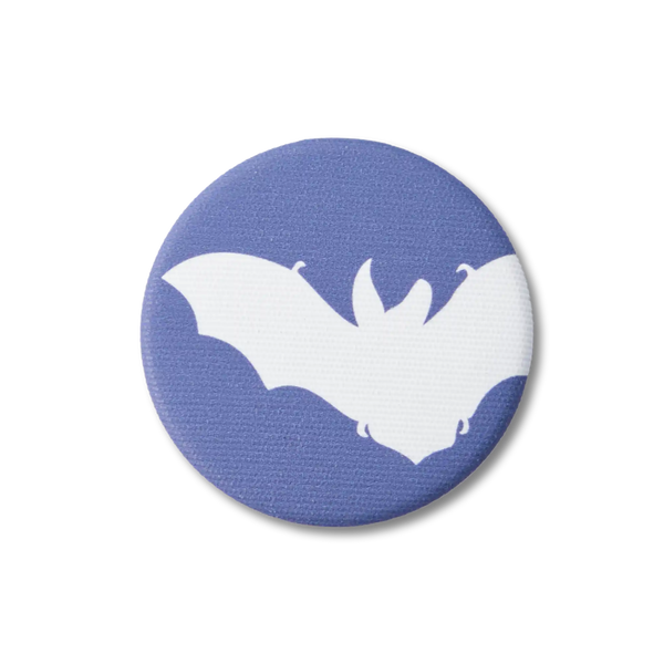 A navy-blue, fabric-covered magnet with the silhouette of a Brown Long-Eared Bat lies on a flat white surface.