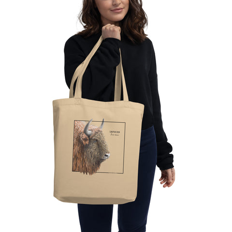 Product mockup of our 100% organic tot bag with a print of a europeant bison (wisent), held by a model.