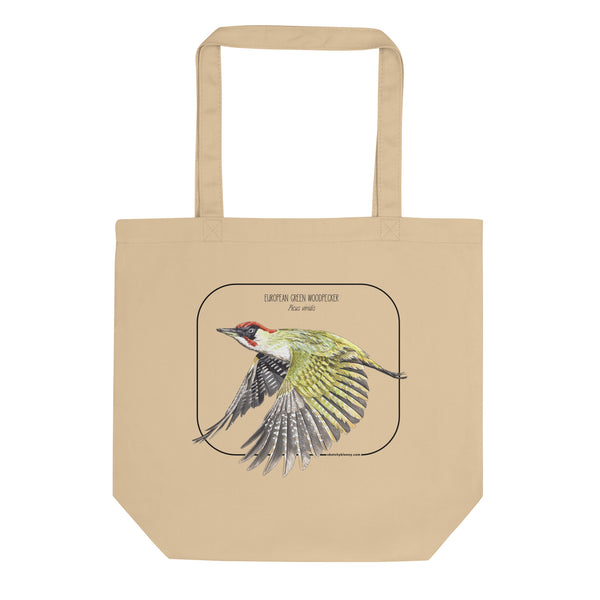 Product mockup of our 100% organic tote bag with a european green woodpecker print. Here lying flat on a white surface.