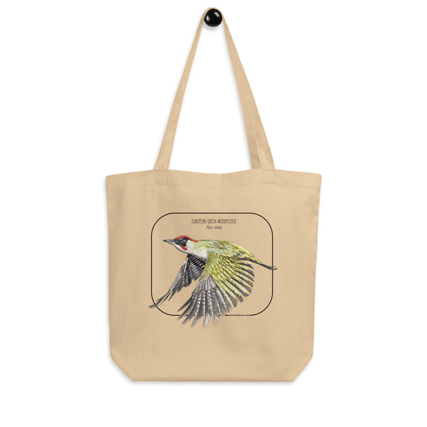 Product mockup of our 100% organic tote bag with a european green woodpecker print. Here hanging drom a wall holder.