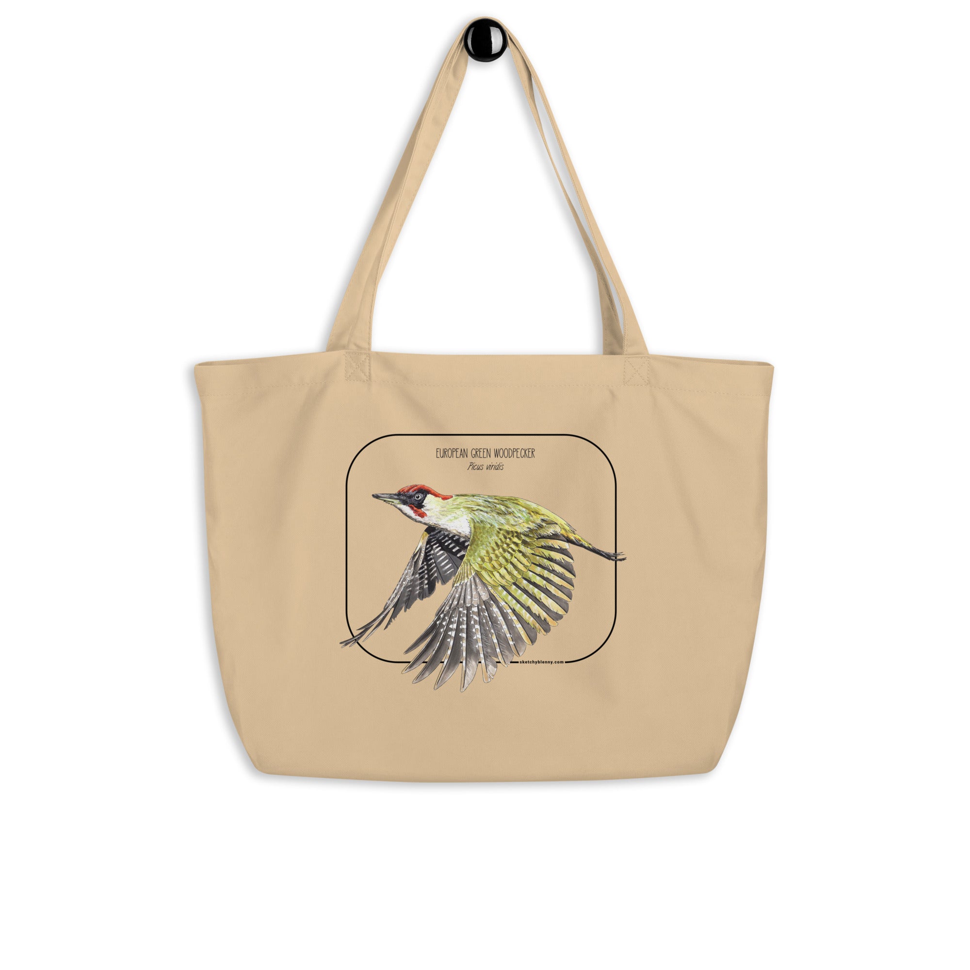 Product mockup of our 100% organic tote bag with a european green woodpecker print. Here seen hanging from a wall holder.