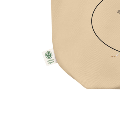 Mock-up of our standard size Orchid mantis tote bag, detail of the organic label tag on the side of the bag. 100%organic cotton, sturdy and spacious.