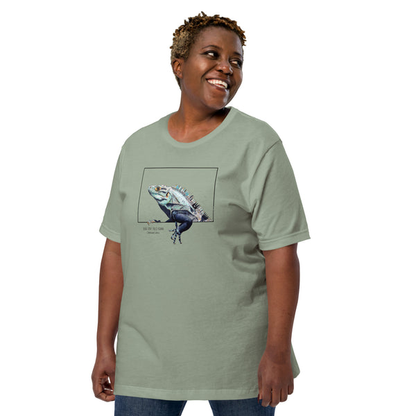 Product mockup of our black iguana t-shirt on a sage base colour. Worn by a  female plus-size model.