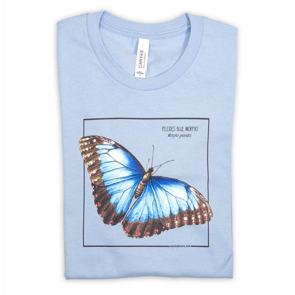 Photo of our baby blue blue morpho butterfly t-shirt folded on a white surface.