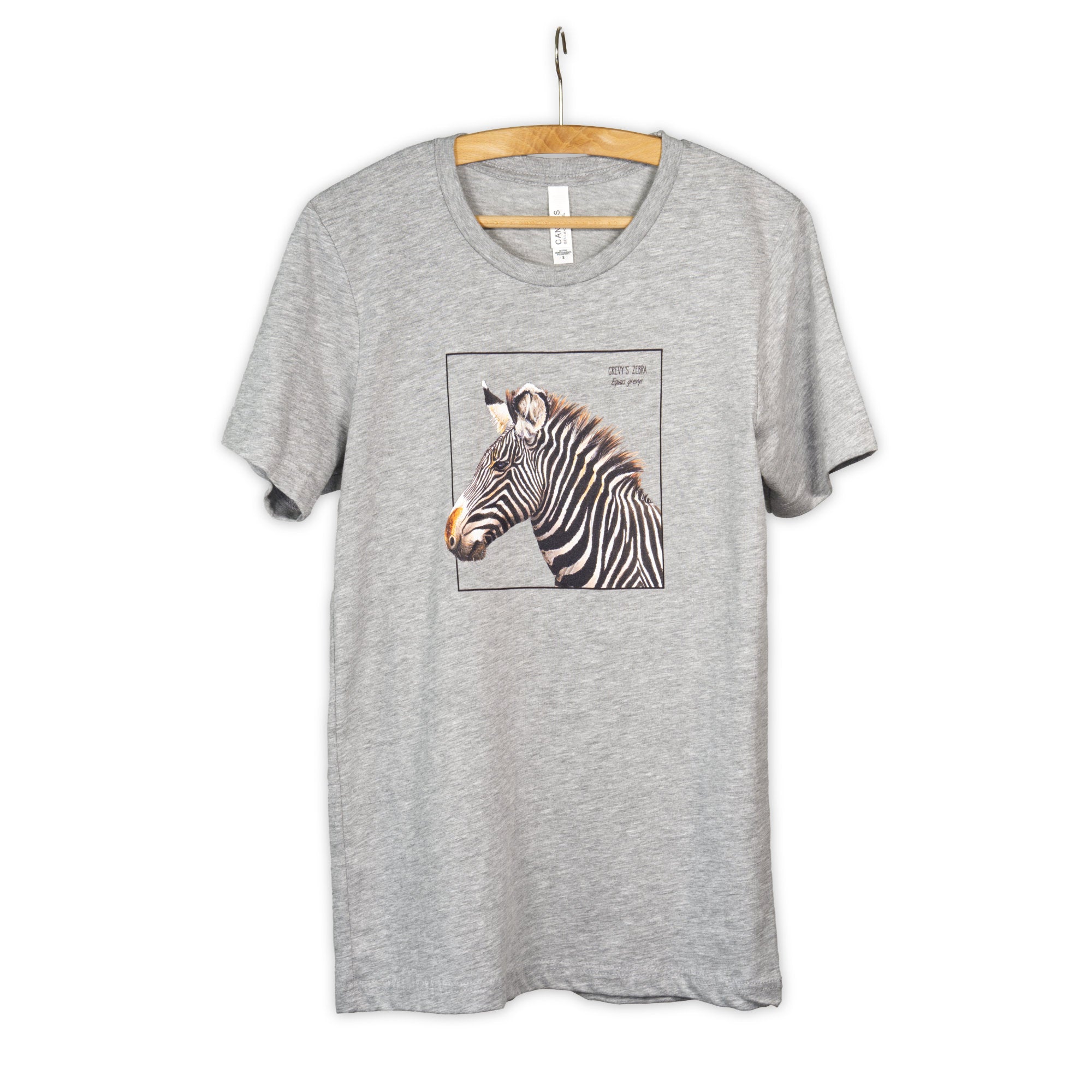 Photo of our gravy zebra t-shirt in the colour heather grey on a wooden hanger.