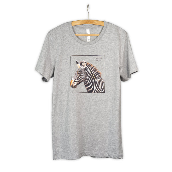 Photo of our gravy zebra t-shirt in the colour heather grey on a wooden hanger.