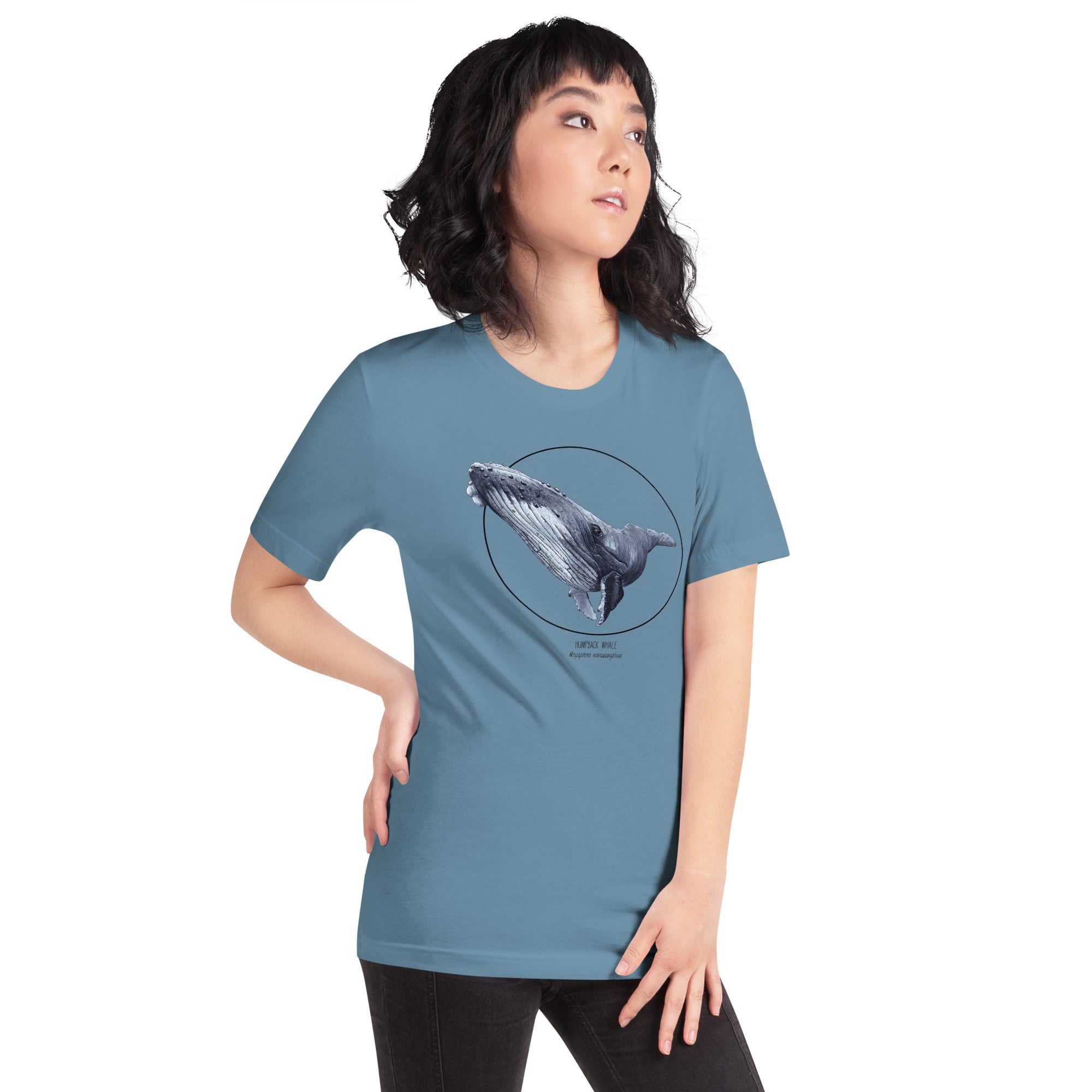 Product mockup of a female model wearing a t-shirt with a beautiful print of a humpbak whale. The base colour of the fabric is steel blue.