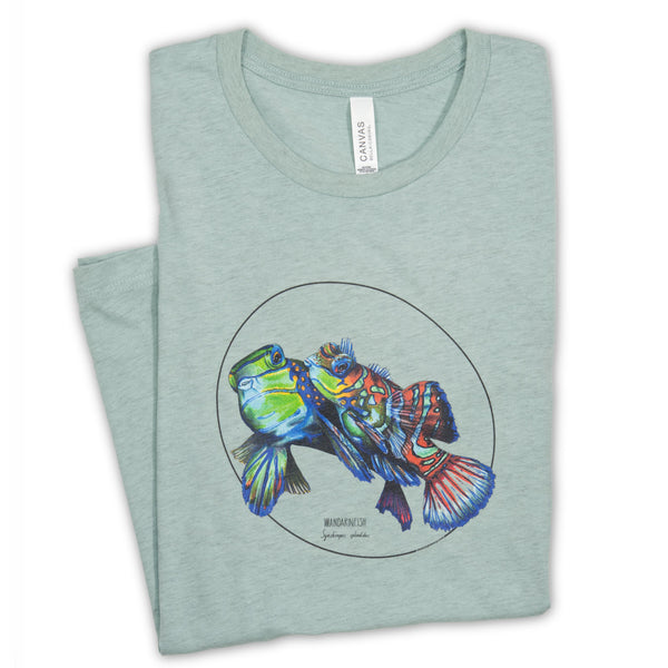 Our colourful mandarinfish print photographed on a heather prism dusty blue coloured t-shirt. Here seen lying folded on a white surface.