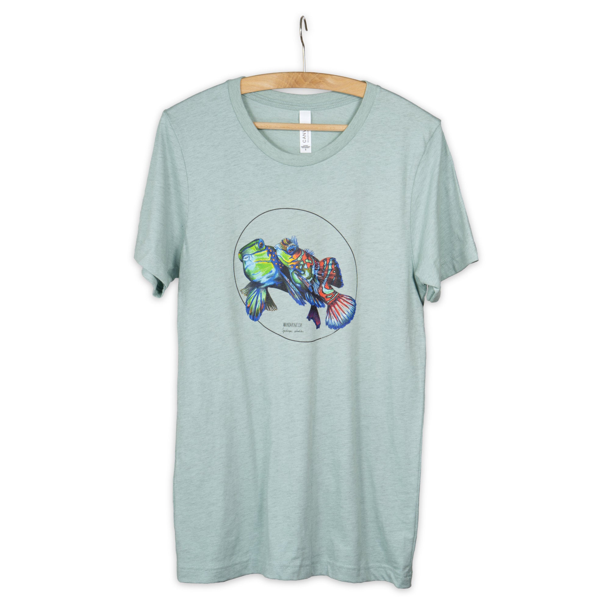 Our colourful mandarinfish print photographed on a heather prism dusty blue coloured t-shirt. Here seen on a wooden hanger.