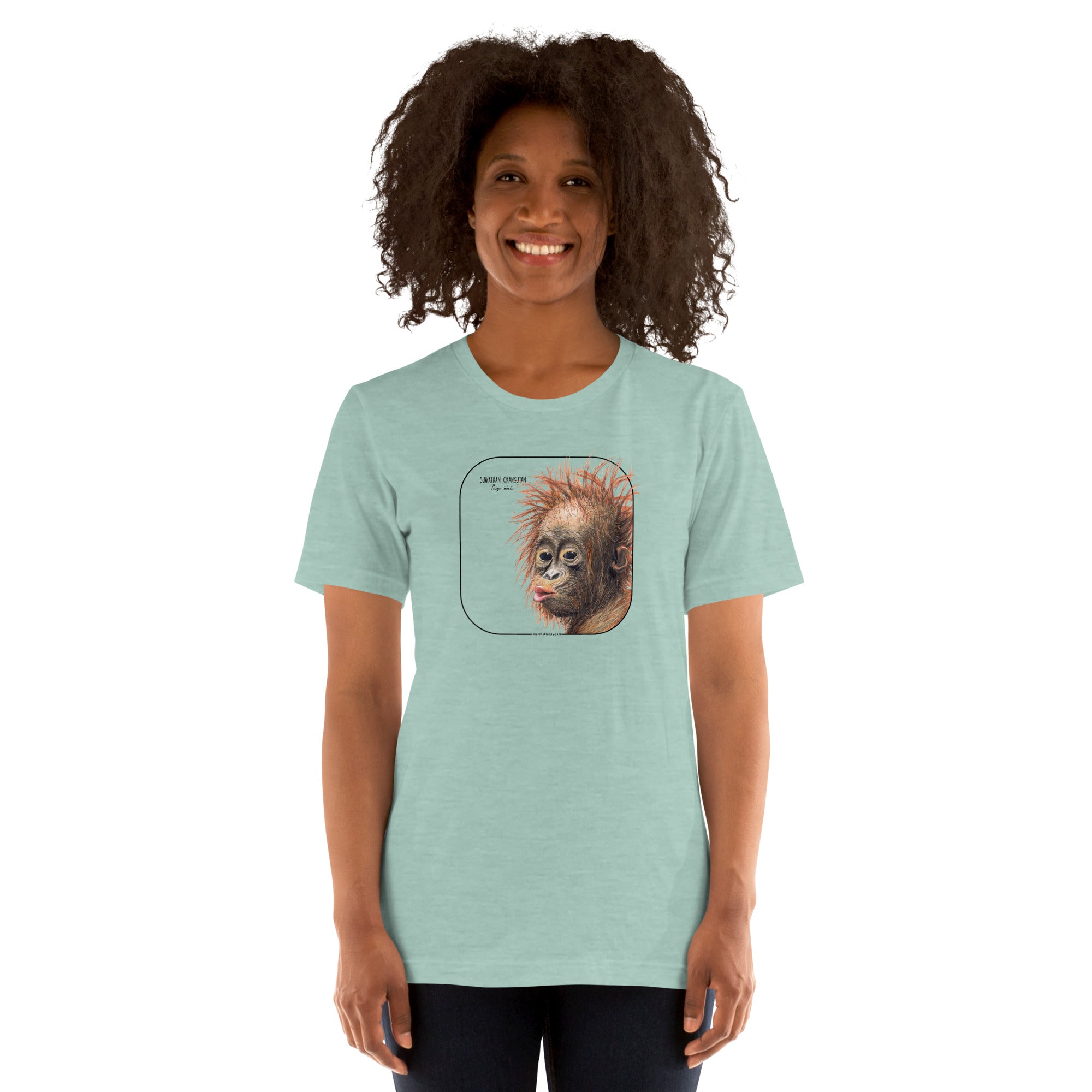 Product mockup showing a female model wearing a t-shirt with a cheeky young sumatran orangutan print. The shirt base colour is heather prism dusty blue.