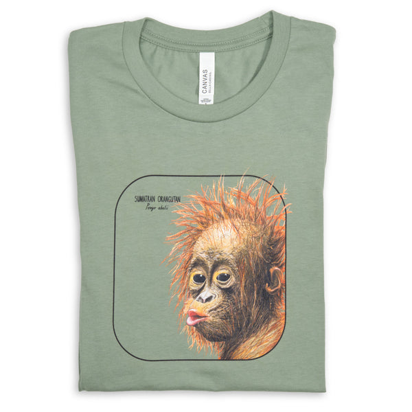 Photo showing our cheeky sumatran orangutan baby smiling from a sage coloured t-shirt lying folded on a white surface.