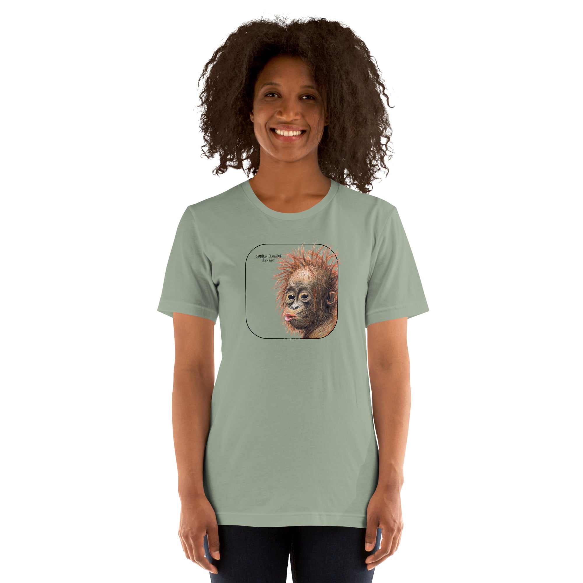 Product mockup showing a female model wearing a t-shirt with a cheeky young sumatran orangutan print. The shirt base colour is sage.