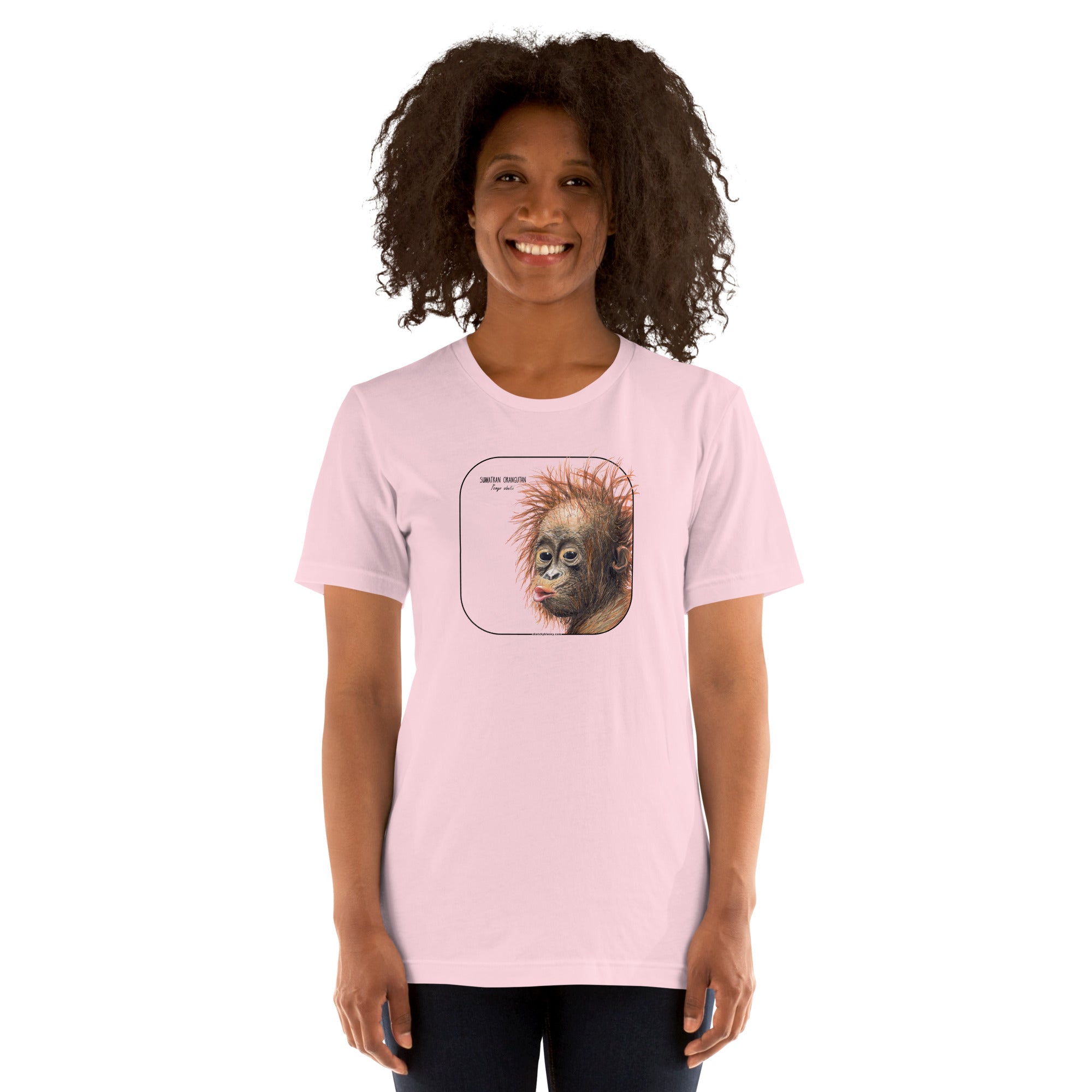 Product mockup showing a female model wearing a t-shirt with a cheeky young sumatran orangutan print. The shirt base colour is soft pink.