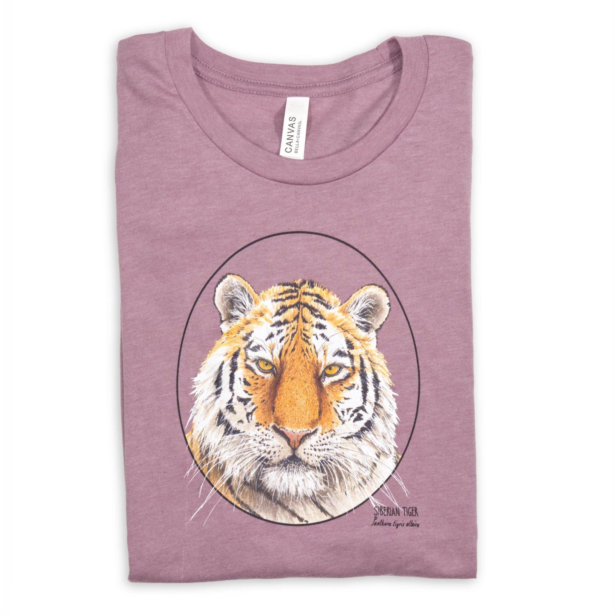 Photo of our t-shirt with a siberian tiger print on a heather orchid coloured fabric. Lying folded on a white surface.