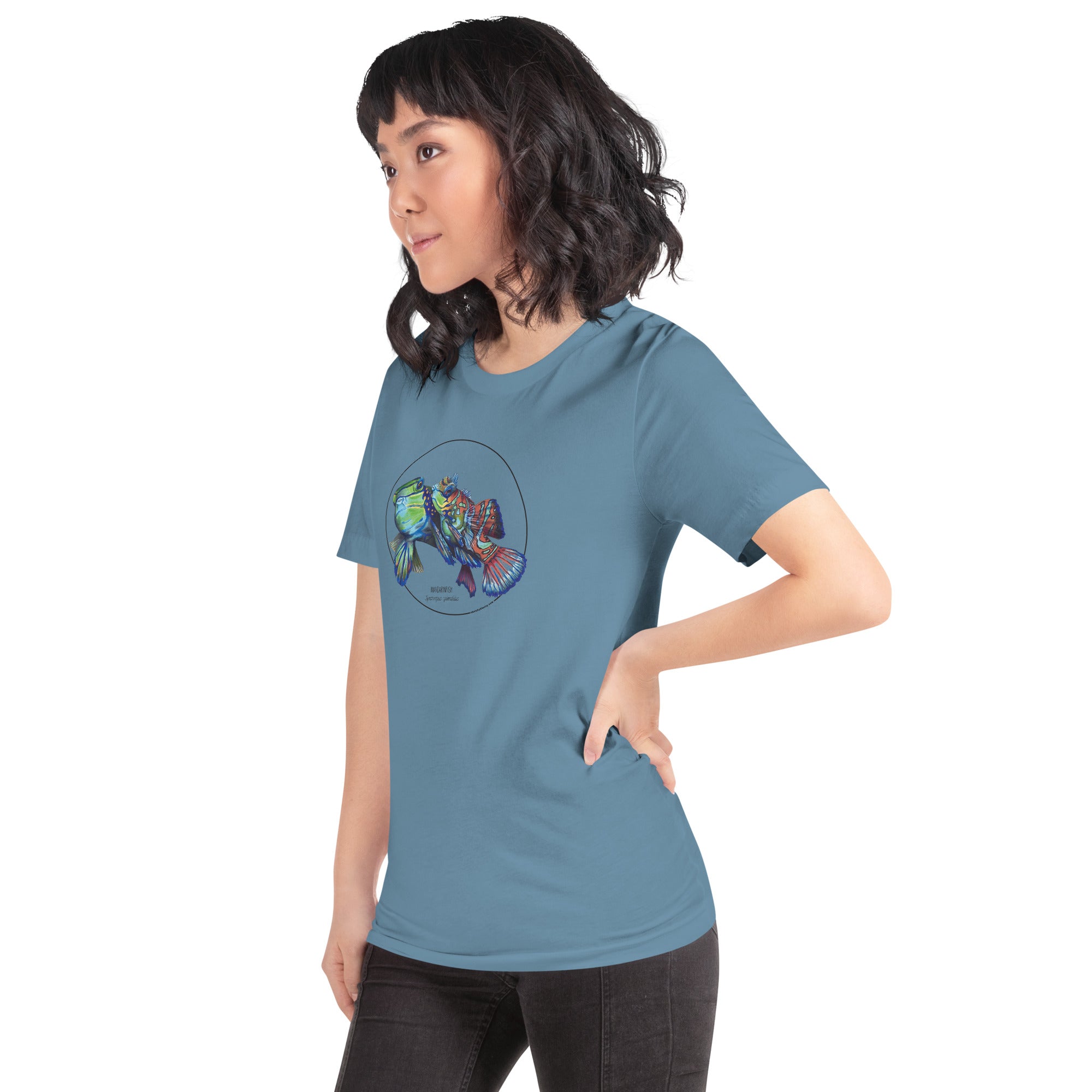 Product mockup showing a female model wearing the t-shirt with a colourful print of two mandarinfish in courtship. Base colour of the shirt is steel blue.