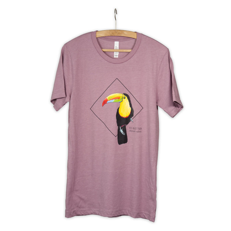 Photo of our stunning keel-billed toucan print, here on a heather orchid coloured t-shirt on a wooden hanger.