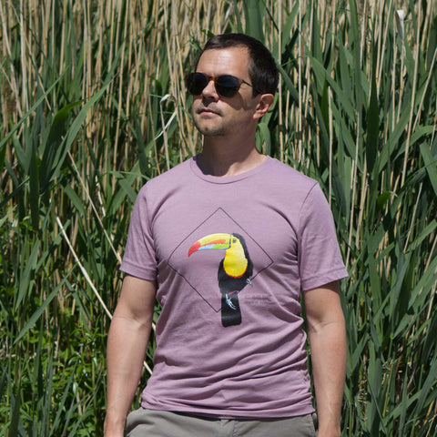 Photoshoot outside on a male model of the keel-billed toucan t-shirt in heather orchid colour.
